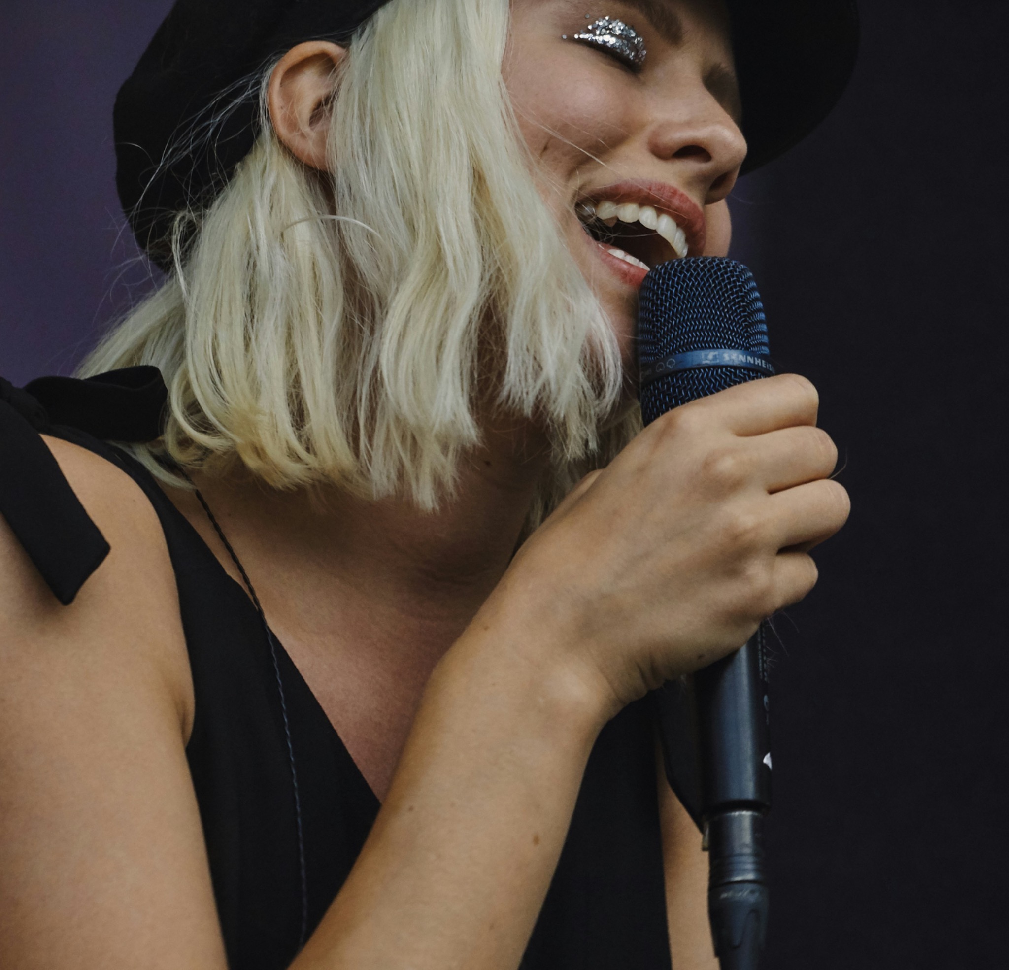 Female singer performing live with a handheld microphone