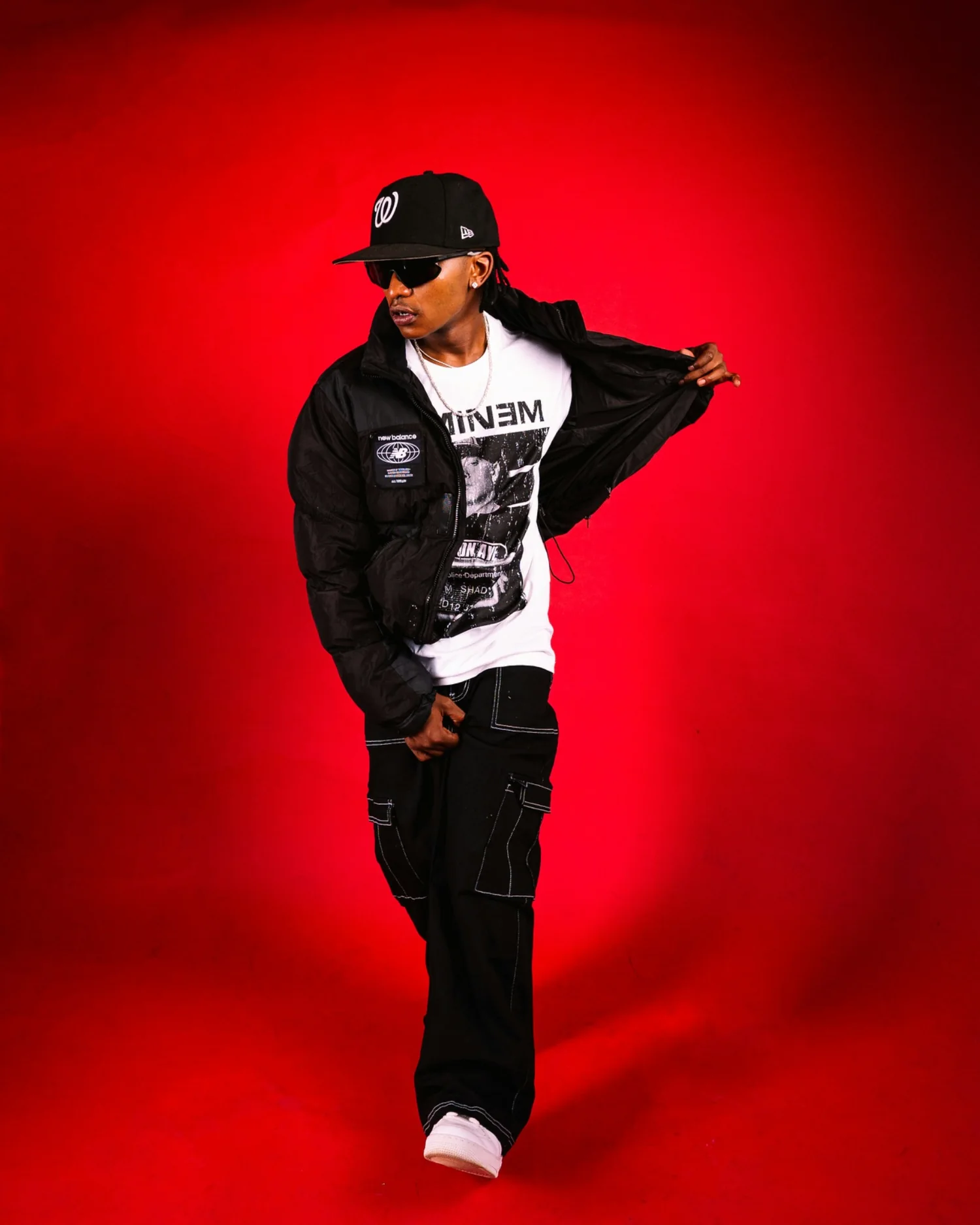 Rap artist performing in front of a red studio background